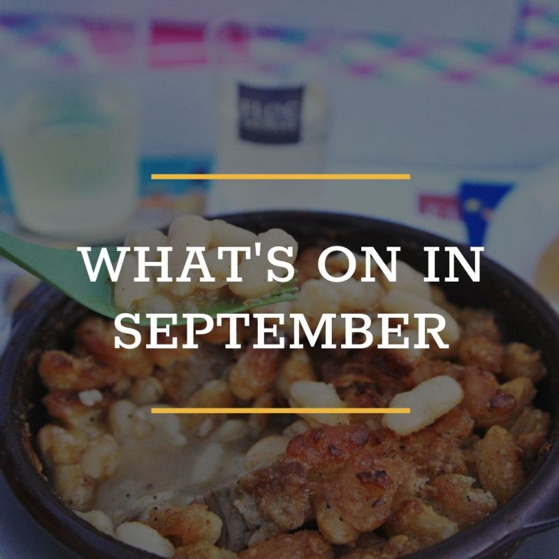 A close-up of a bowl of food being eaten with a green fork, overlaid with the text "WHAT'S ON IN SEPTEMBER" in bold white letters and yellow lines, highlights September Food Events you won't want to miss.