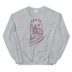Gray "Sweatshirt with Logo - Wine" featuring a minimalist maroon line drawing of Toulouse landmarks, cheese, wine, and a croissant, with "Taste of Toulouse" above and below the illustration.