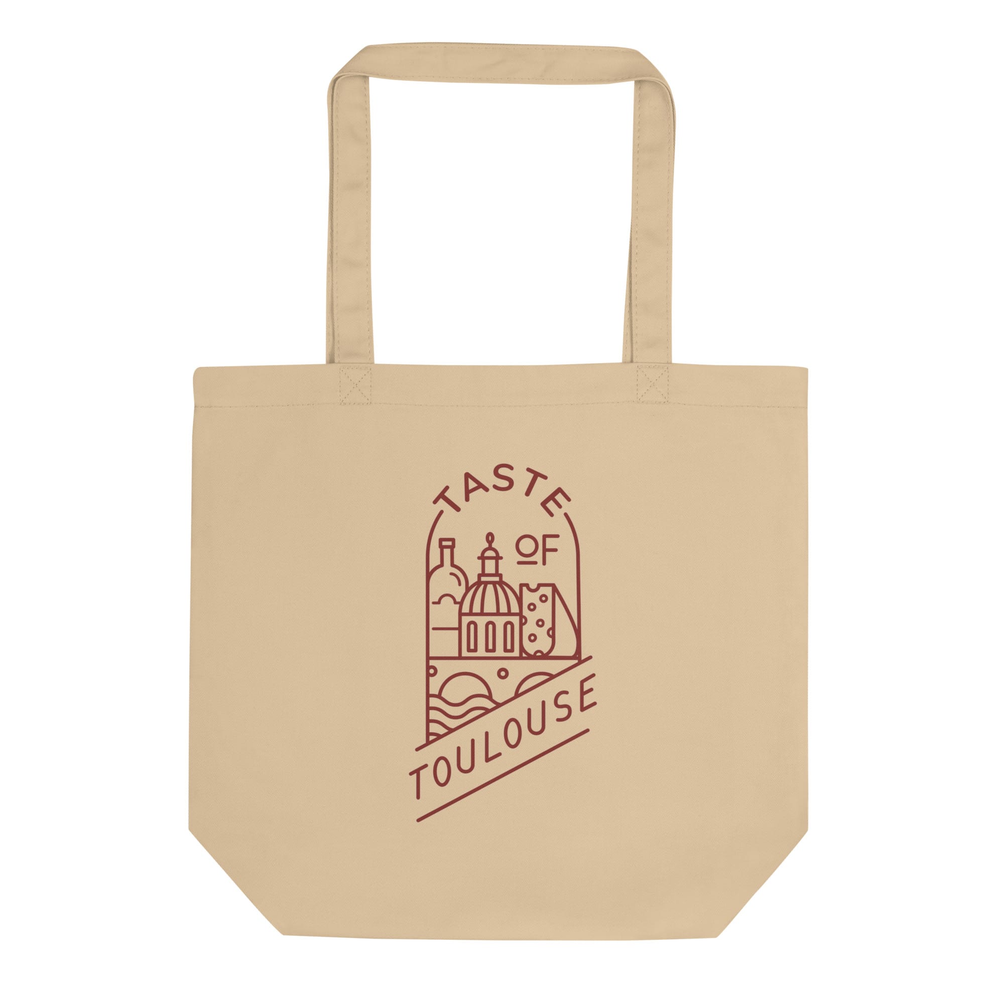 The Tote Bag with Red Logo is beige and features a maroon cityscape line drawing with a dome, cheese, bread, "Taste of Toulouse" text, and a stylish red logo.